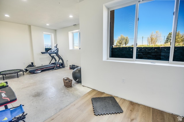 workout area with recessed lighting and wood finished floors