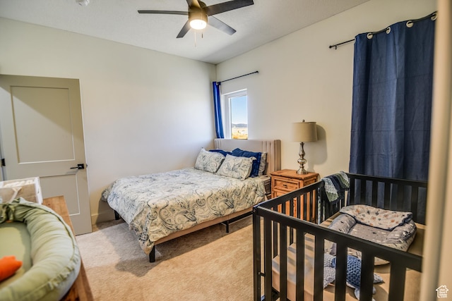 carpeted bedroom featuring a ceiling fan