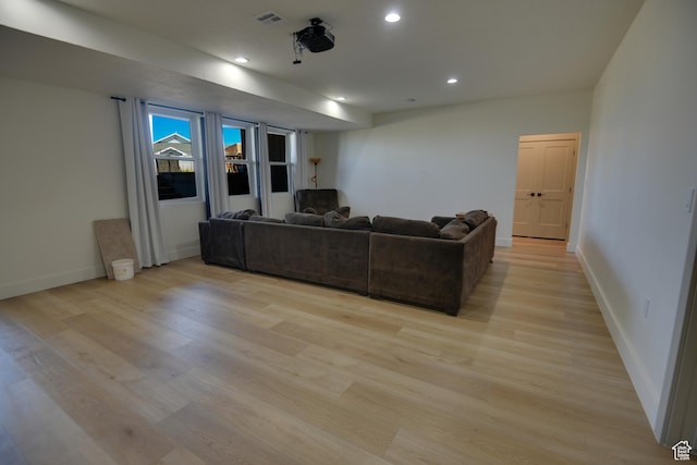 living room featuring recessed lighting, baseboards, visible vents, and light wood-type flooring