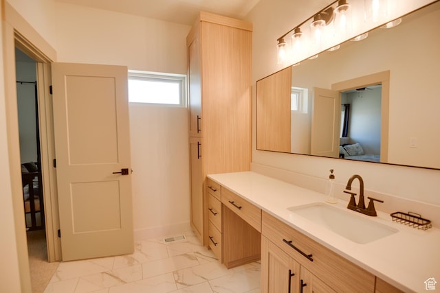 bathroom featuring vanity, marble finish floor, and ensuite bath