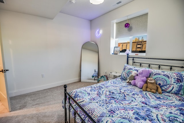 carpeted bedroom featuring visible vents and baseboards