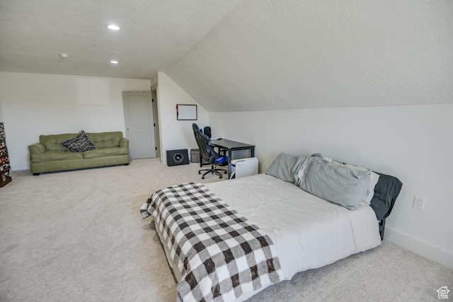 carpeted bedroom with vaulted ceiling, recessed lighting, and a textured ceiling