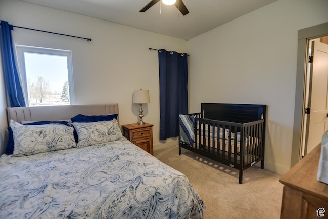 bedroom featuring a ceiling fan and light carpet