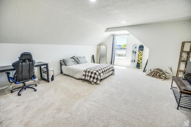 bedroom with carpet flooring, a textured ceiling, and vaulted ceiling
