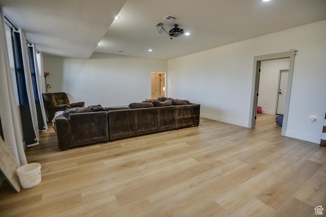 living room featuring light wood-style floors, recessed lighting, baseboards, and visible vents