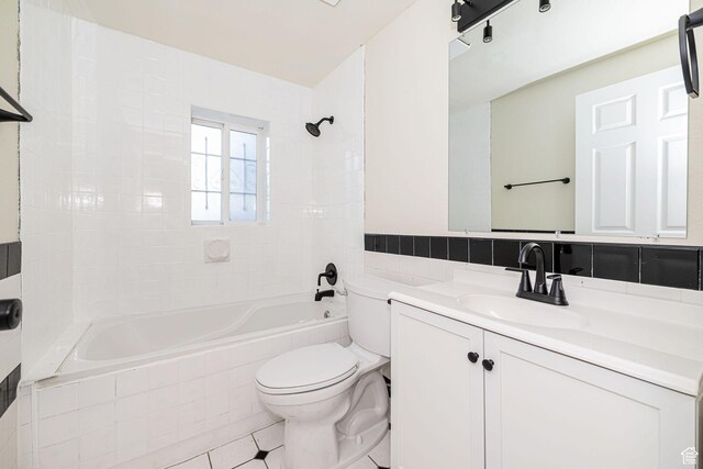 916 W 1150 S, Provo, UT 84601 - bathroom with tile walls, tile patterned flooring, vanity, tiled shower / bath, and toilet