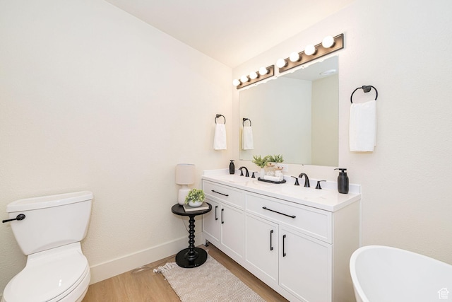 916 W 1150 S, Provo, UT 84601 - bathroom with double vanity, a freestanding bath, wood finished floors, a sink, and toilet