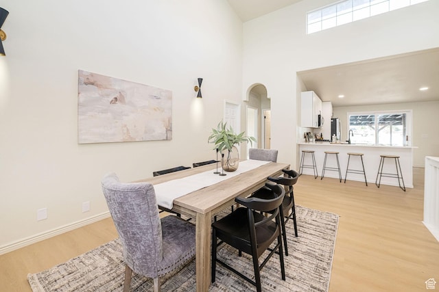 916 W 1150 S, Provo, UT 84601 - dining area with baseboards, a high ceiling, recessed lighting, arched walkways, and light wood finished floors
