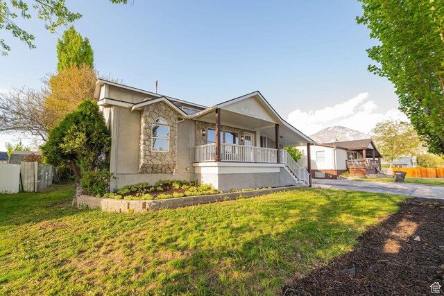 916 W 1150 S, Provo, UT 84601 - single story home featuring covered porch, fence, a front lawn, stone siding, and stucco siding