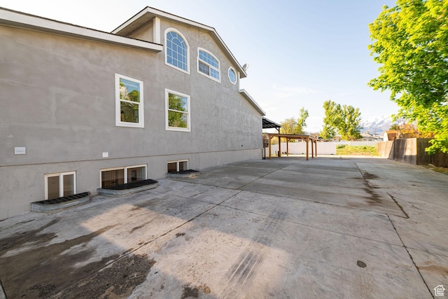 916 W 1150 S, Provo, UT 84601 - rear view of house featuring stucco siding, a patio area, fence, and a pergola