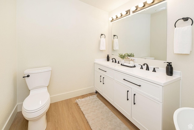 916 W 1150 S, Provo, UT 84601 - bathroom with double vanity, wood finished floors, a sink, baseboards, and toilet