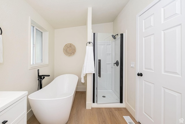 916 W 1150 S, Provo, UT 84601 - full bath featuring visible vents, a freestanding bath, a stall shower, wood finished floors, and vanity