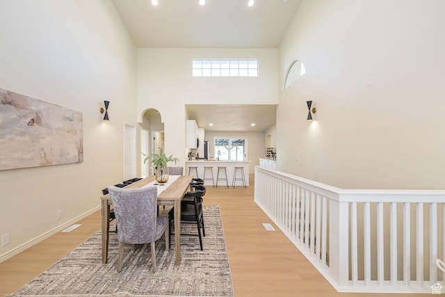 916 W 1150 S, Provo, UT 84601 - dining area featuring recessed lighting, arched walkways, light wood finished floors, and a towering ceiling