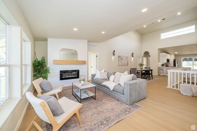 916 W 1150 S, Provo, UT 84601 - living room featuring visible vents, arched walkways, a fireplace, light wood-style floors, and recessed lighting