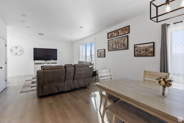 889 N 900 W, Tremonton, UT 84337 - dining space featuring baseboards, visible vents, and wood finished floors