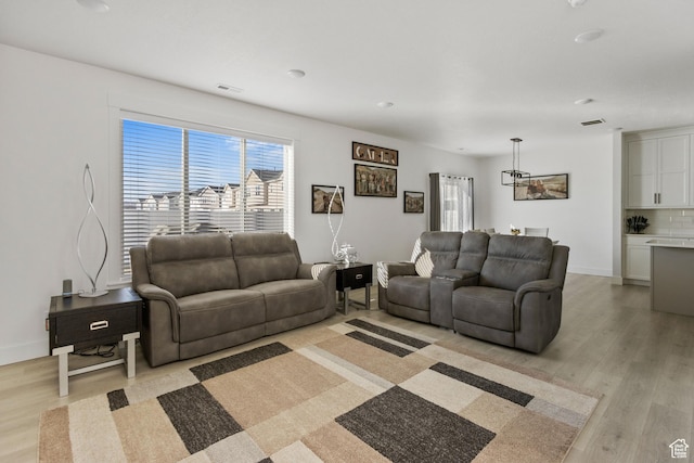 889 N 900 W, Tremonton, UT 84337 - living room with visible vents, light wood finished floors, and baseboards