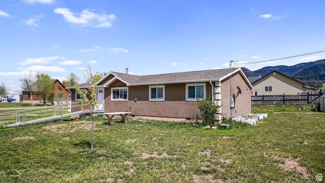 84 N 100 W, Sterling, UT 84665 - single story home with a fenced backyard, stucco siding, and a front yard