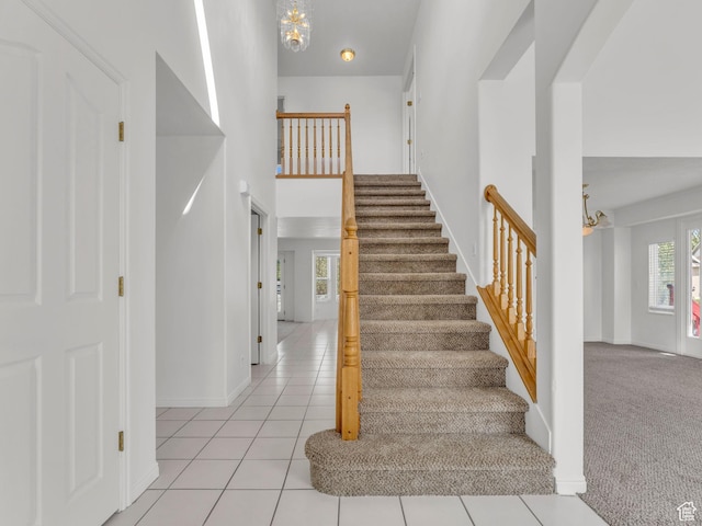1788 W Nobility Cir, Salt Lake City, UT 84116 - staircase with tile patterned flooring, baseboards, a high ceiling, and a chandelier