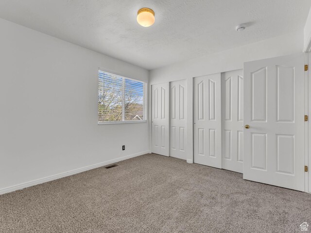 1788 W Nobility Cir, Salt Lake City, UT 84116 - unfurnished bedroom featuring multiple closets, baseboards, carpet floors, and visible vents