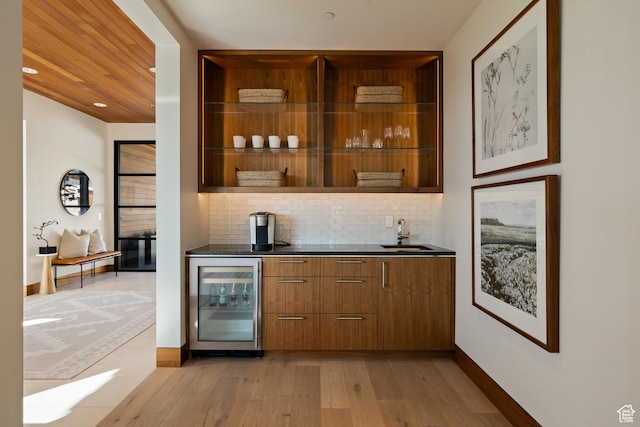 772 S Summit Creek Dr, Woodland Hills, UT 84653 - indoor wet bar featuring beverage cooler, light wood-style floors, decorative backsplash, and baseboards