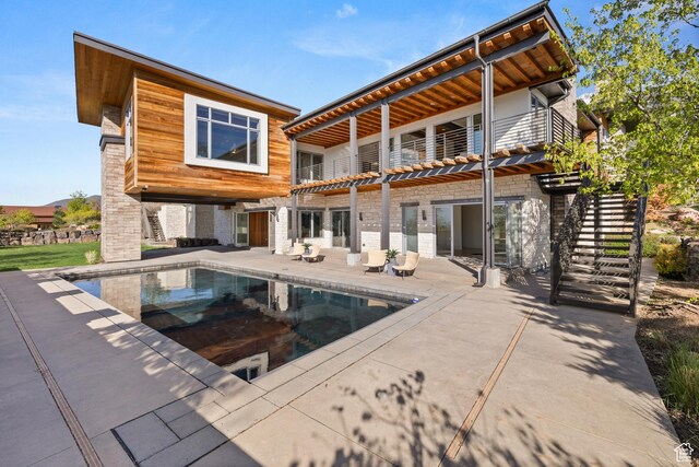 772 S Summit Creek Dr, Woodland Hills, UT 84653 - rear view of property featuring a balcony, a patio, an outdoor pool, and stairs
