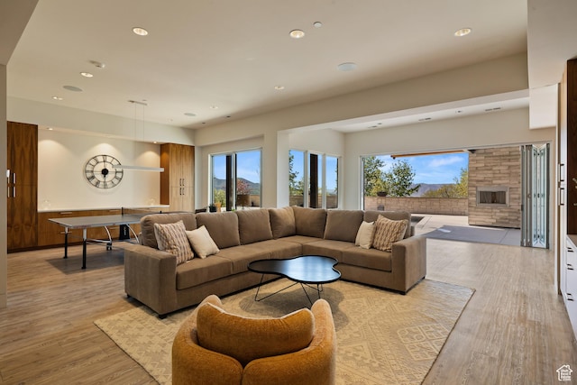 772 S Summit Creek Dr, Woodland Hills, UT 84653 - living room with light wood-style floors, a stone fireplace, and recessed lighting