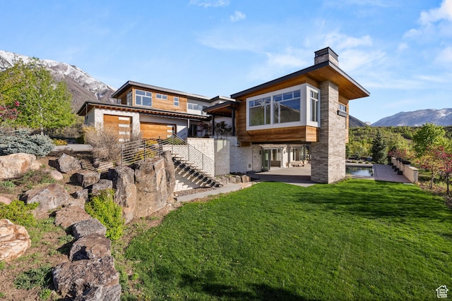 772 S Summit Creek Dr, Woodland Hills, UT 84653 - rear view of property with stairs, a chimney, a patio area, a lawn, and a mountain view