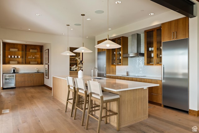 772 S Summit Creek Dr, Woodland Hills, UT 84653 - kitchen with wall chimney exhaust hood, built in fridge, beverage cooler, a sink, and black electric stovetop