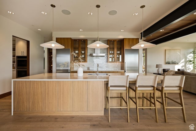772 S Summit Creek Dr, Woodland Hills, UT 84653 - kitchen with modern cabinets, multiple ovens, backsplash, a large island with sink, and recessed lighting