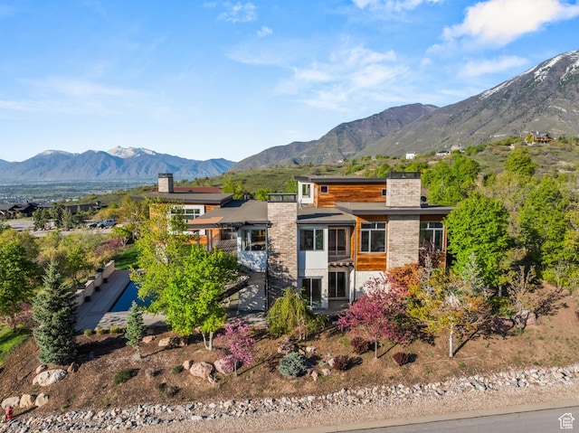 772 S Summit Creek Dr, Woodland Hills, UT 84653 - view of front facade featuring a chimney, a sunroom, and a mountain view