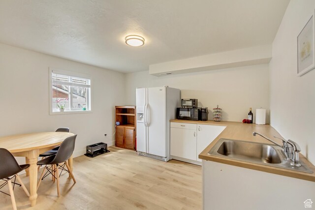 584 E Aspen Way, Centerville, UT 84014 - kitchen featuring a sink, white refrigerator with ice dispenser, light wood finished floors, light countertops, and white cabinetry