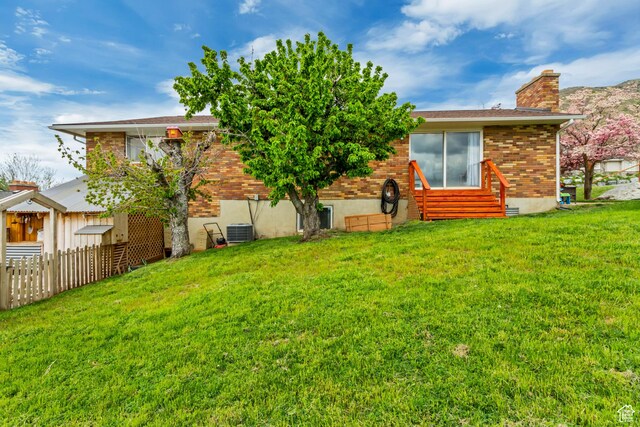 584 E Aspen Way, Centerville, UT 84014 - back of house with fence, central AC unit, a chimney, and a yard