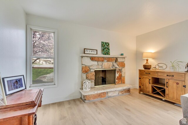584 E Aspen Way, Centerville, UT 84014 - living area featuring light wood finished floors and a fireplace