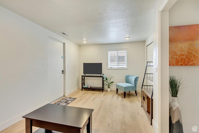 584 E Aspen Way, Centerville, UT 84014 - living area with visible vents, light wood-style flooring, and baseboards