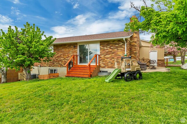 584 E Aspen Way, Centerville, UT 84014 - rear view of property featuring a patio, a chimney, brick siding, entry steps, and a yard