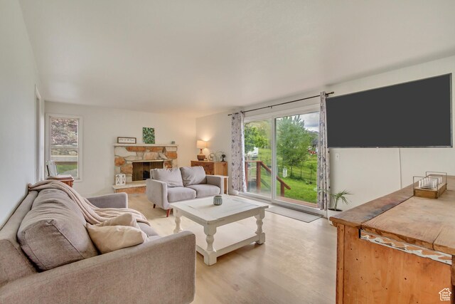 584 E Aspen Way, Centerville, UT 84014 - living room with light wood-style floors and a fireplace