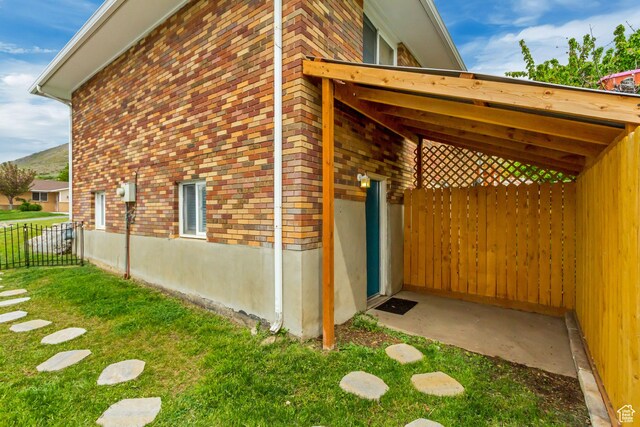 584 E Aspen Way, Centerville, UT 84014 - view of side of property with a lawn, brick siding, and fence