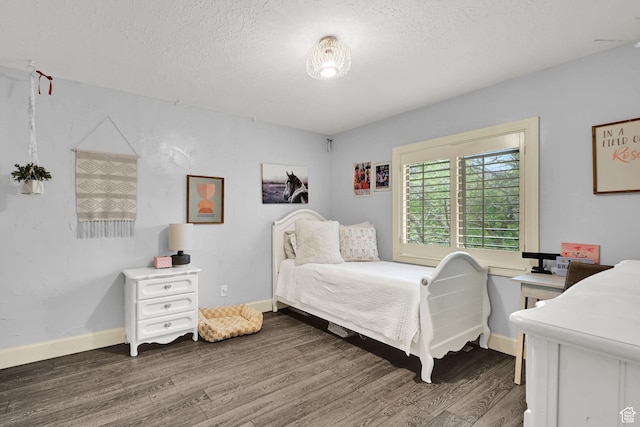 5078 S Iroquois Way E, Ogden, UT 84403 - bedroom with baseboards, a textured ceiling, and wood finished floors