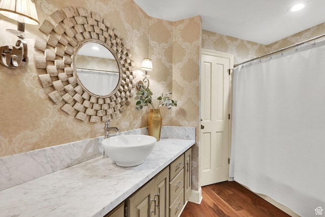 5078 S Iroquois Way E, Ogden, UT 84403 - bathroom with vanity, a shower with shower curtain, wood finished floors, and wallpapered walls