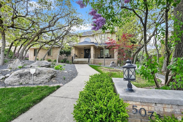 5078 S Iroquois Way E, Ogden, UT 84403 - view of front facade featuring a porch and brick siding