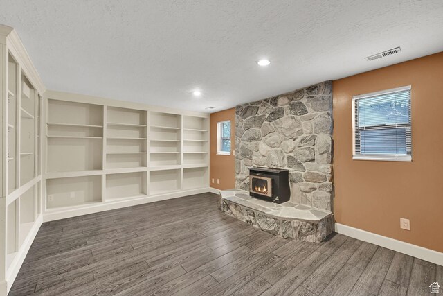 5078 S Iroquois Way E, Ogden, UT 84403 - unfurnished living room featuring baseboards, a textured ceiling, wood finished floors, and visible vents
