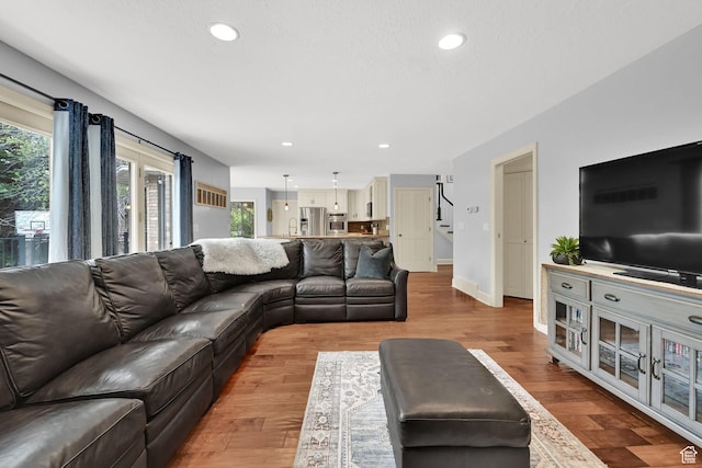 5078 S Iroquois Way E, Ogden, UT 84403 - living room featuring recessed lighting, baseboards, stairs, and wood finished floors