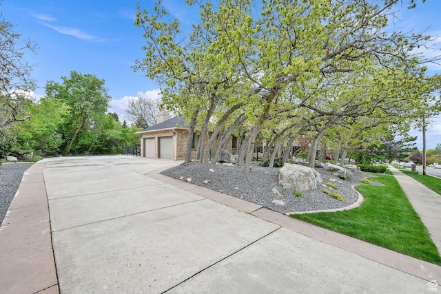 5078 S Iroquois Way E, Ogden, UT 84403 - view of front facade with an attached garage, concrete driveway, and brick siding