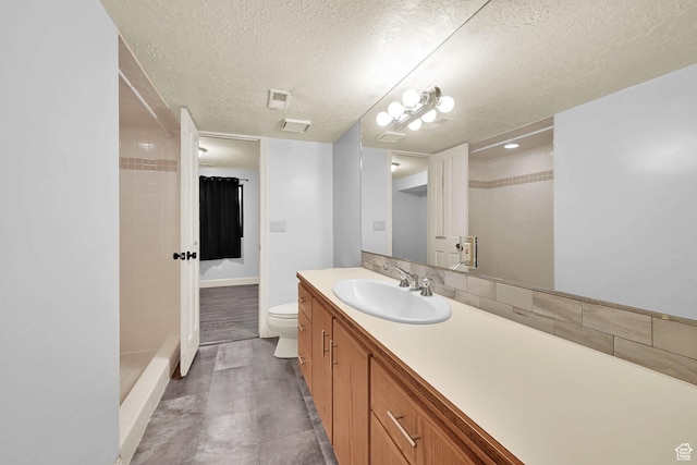 5078 S Iroquois Way E, Ogden, UT 84403 - bathroom with a textured ceiling, a shower, vanity, baseboards, and toilet