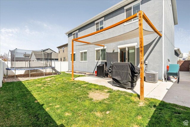 204 E 460 N, Vineyard, UT 84059 - rear view of house with a fenced backyard, a trampoline, and a patio area