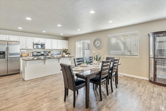 204 E 460 N, Vineyard, UT 84059 - dining area with light wood-style floors, recessed lighting, a textured ceiling, and baseboards