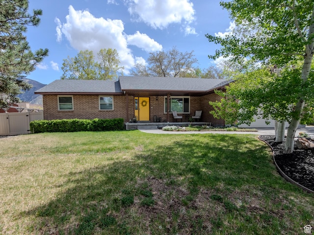 1612 E Hidden Valley Rd, Sandy, UT 84092 - ranch-style house with fence, an attached garage, a front lawn, brick siding, and a gate