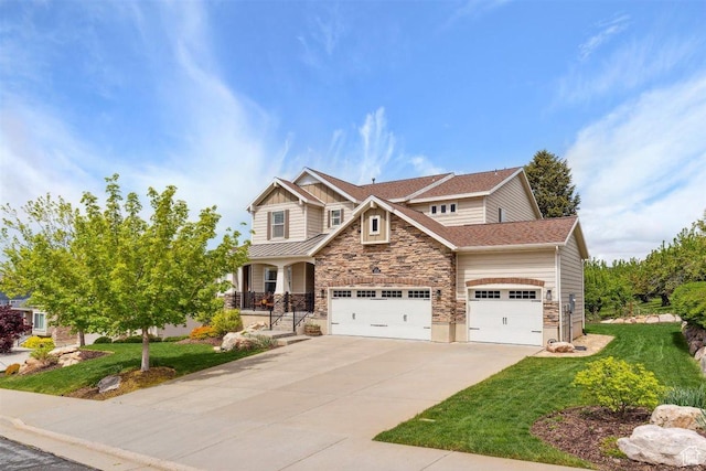 craftsman inspired home featuring roof with shingles, stone siding, a garage, a front yard, and concrete driveway