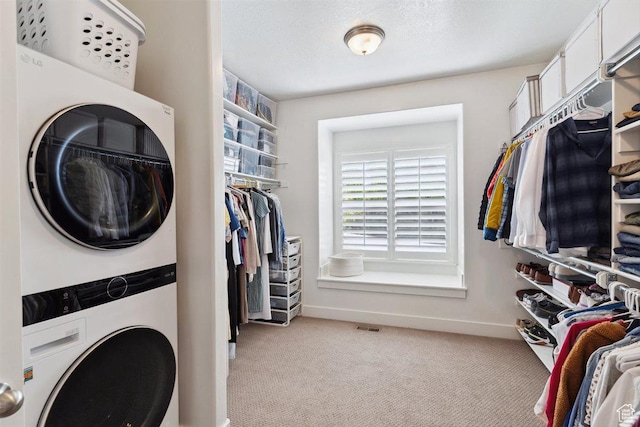 1485 E Peachtree Ln, Fruit Heights, UT 84037 - laundry room featuring laundry area, visible vents, baseboards, light carpet, and stacked washer and clothes dryer