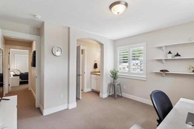 1485 E Peachtree Ln, Fruit Heights, UT 84037 - home office featuring baseboards, arched walkways, and light carpet